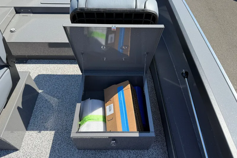Slide: The Image of Open storage compartment on 2026 Alumaweld Free Drifter 20 boat, containing packaged items. - 27