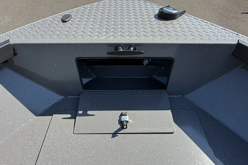 Slide: The Image of 2026 Alumaweld Free Drifter 20 boat interior with storage compartment and diamond plate flooring. - 16