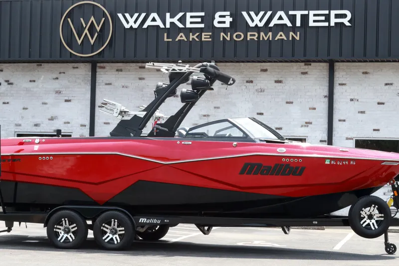 Slide: The Image of 2023 Malibu Wakesetter 25 LSV boat in vibrant red at Wake & Water Lake Norman. - 0