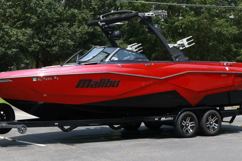 Slide: The Image of 2023 Malibu Wakesetter 25 LSV boat in vibrant red on a trailer. - 20