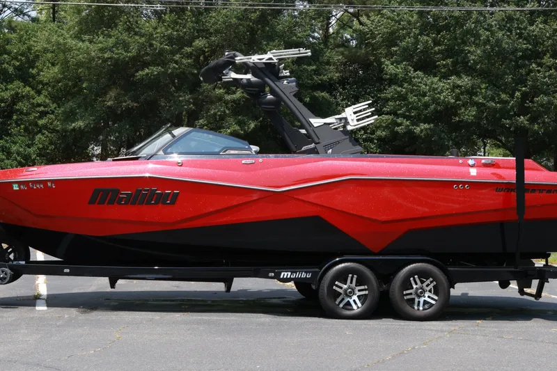 Slide: The Image of 2023 Malibu Wakesetter 25 LSV boat in vibrant red on a trailer. - 21
