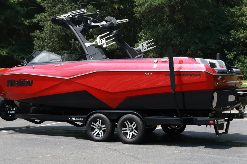 Slide: The Image of 2023 Malibu Wakesetter 25 LSV boat in vibrant red on a trailer. - 22