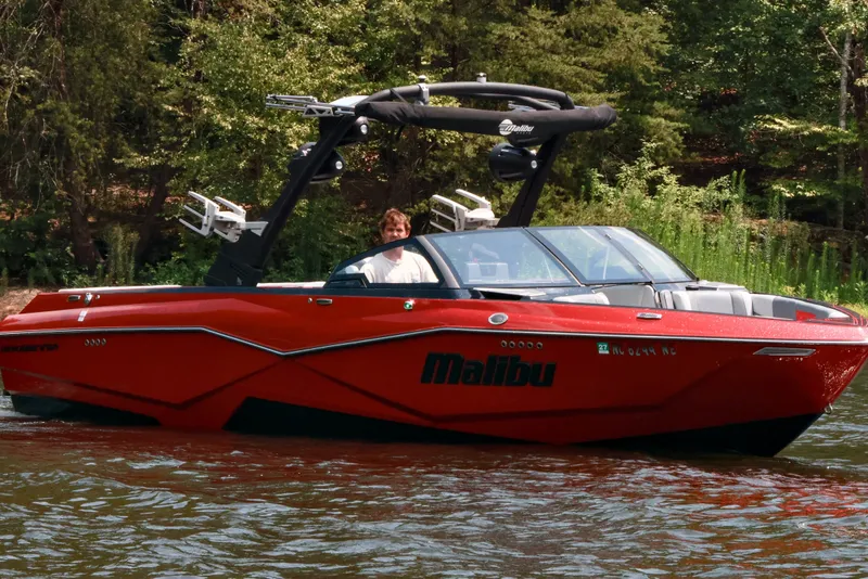 Slide: The Image of 2023 Malibu Wakesetter 25 LSV boat on a scenic lake. - 8
