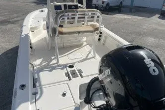 Slide: The Image of 2023 NauticStar 227 XTS boat with Mercury 150 engine, docked outdoors. - 7