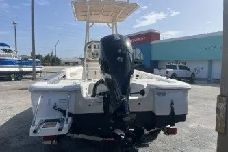 Slide: The Image of 2023 NauticStar 227 XTS boat with outboard motor in a marina setting. - 6