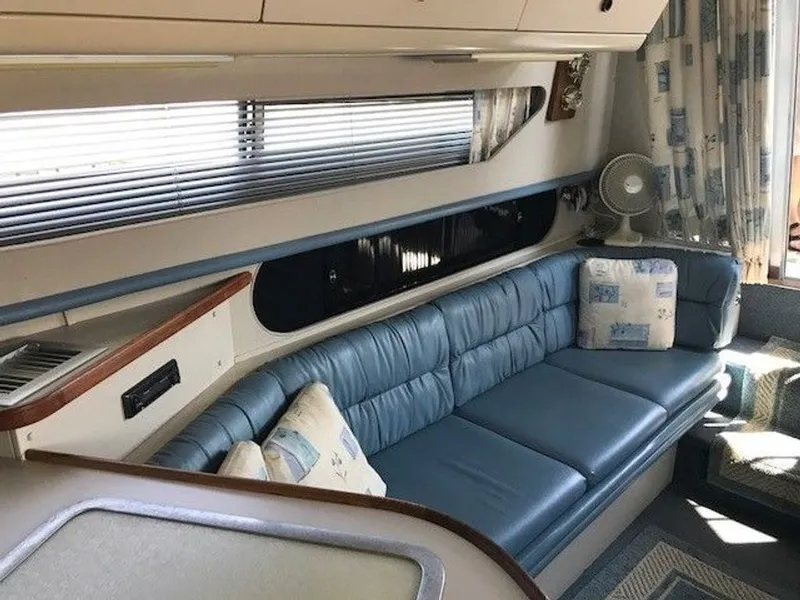 Slide: The Image of Interior of a 1989 Carver 3067 Santego with blue upholstery and decorative pillows. - 10