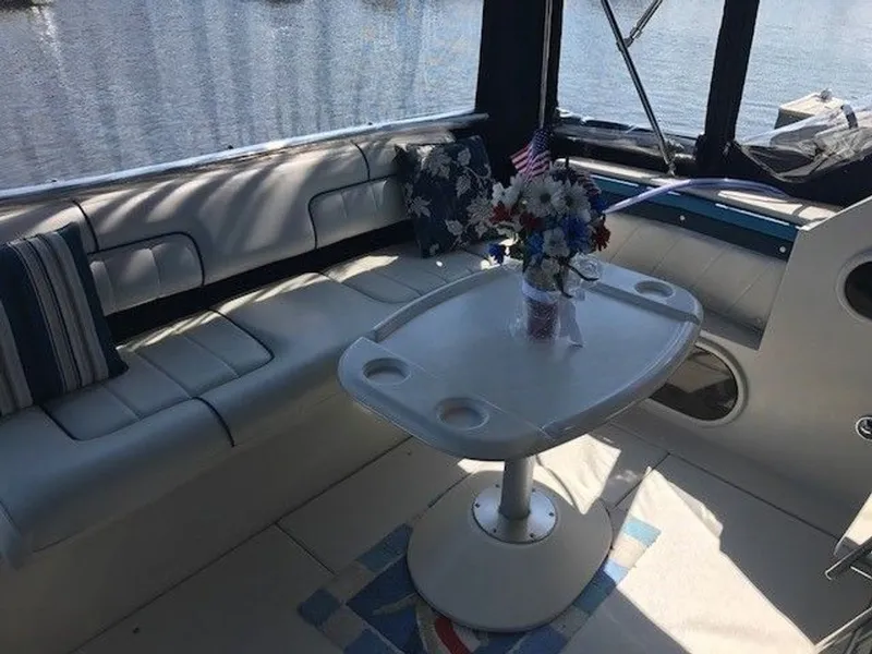 Slide: The Image of The image shows the interior of a 1989 Carver 3067 Santego with seating area and table. - 7
