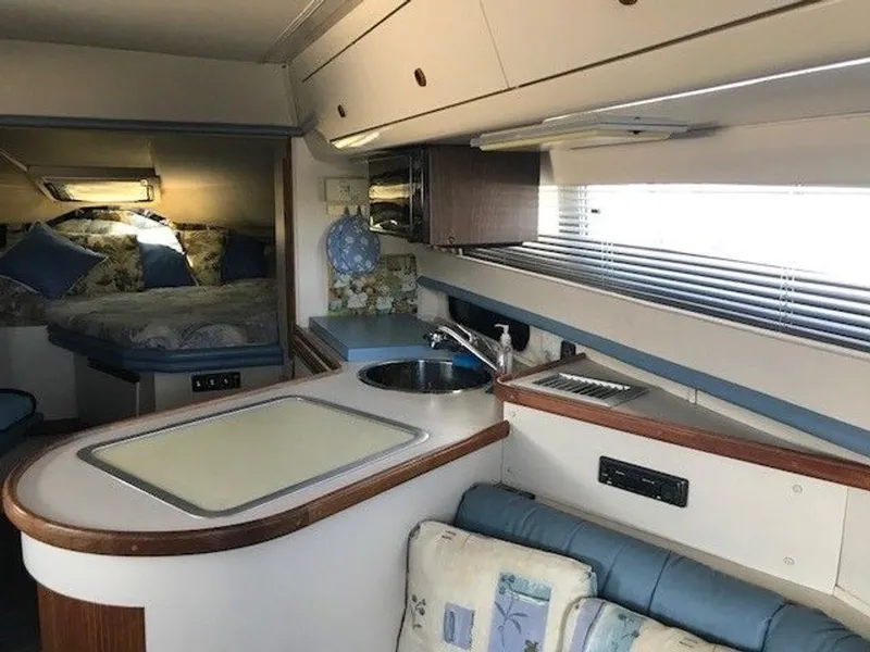Slide: The Image of Interior of a 1989 Carver 3067 Santego featuring a kitchenette, sink, and cozy sleeping area. - 9