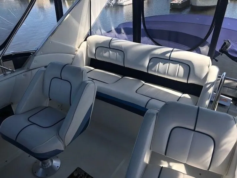 Slide: The Image of The image shows the interior of a 1989 Carver 3067 Santego with white upholstered seating. - 5