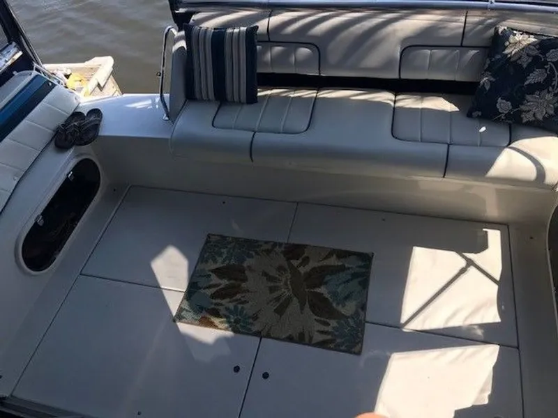 Slide: The Image of The image shows the cockpit of a 1989 Carver 3067 Santego with white upholstery and cushions. - 6