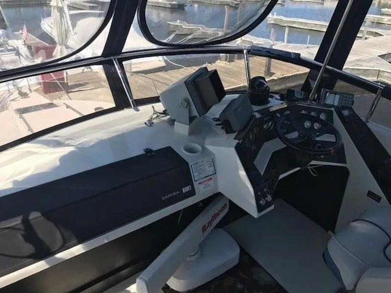 Slide: The Image of The cockpit of a 1989 Carver 3067 Santego with steering wheel, instruments, and screens. - 3