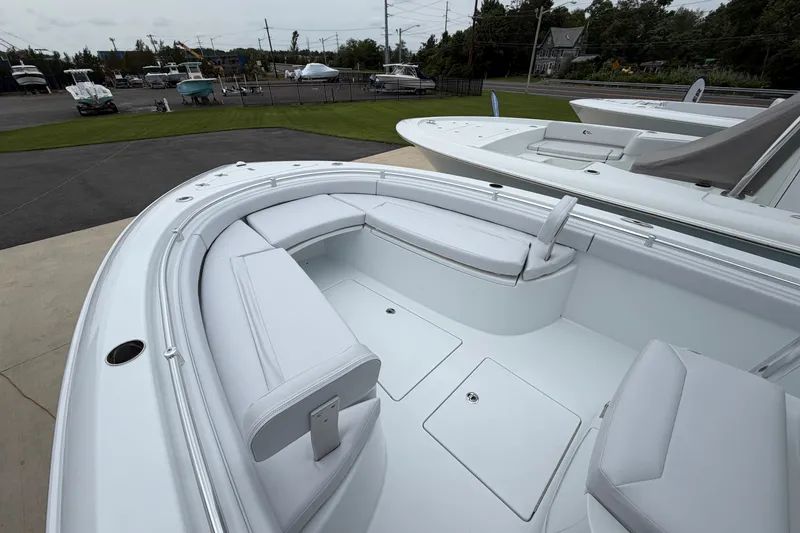 Slide: The Image of 2027 Contender 24 Sport boat with sleek white seating and spacious deck layout. - 5