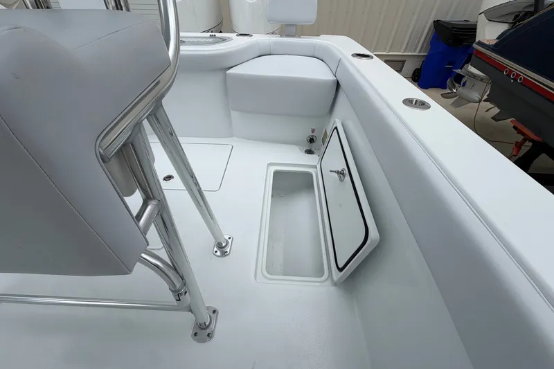 Slide: The Image of Contender 24 Sport 2027 boat interior with open storage compartment and seating. - 14