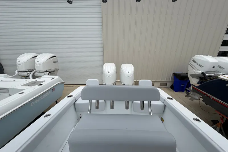 Slide: The Image of 2027 Contender 24 Sport boat with dual Yamaha outboard engines in a storage area. - 11