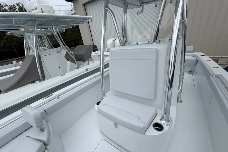 Slide: The Image of 2027 Contender 24 Sport boat interior with sleek seating and polished metal framework. - 7