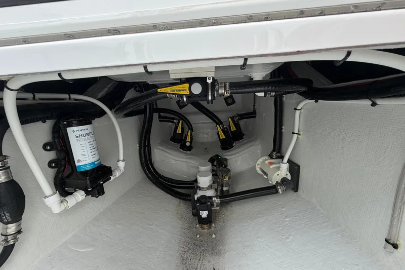 Slide: The Image of Interior view of 2027 Contender 24 Sport boat's plumbing and wiring system. - 16