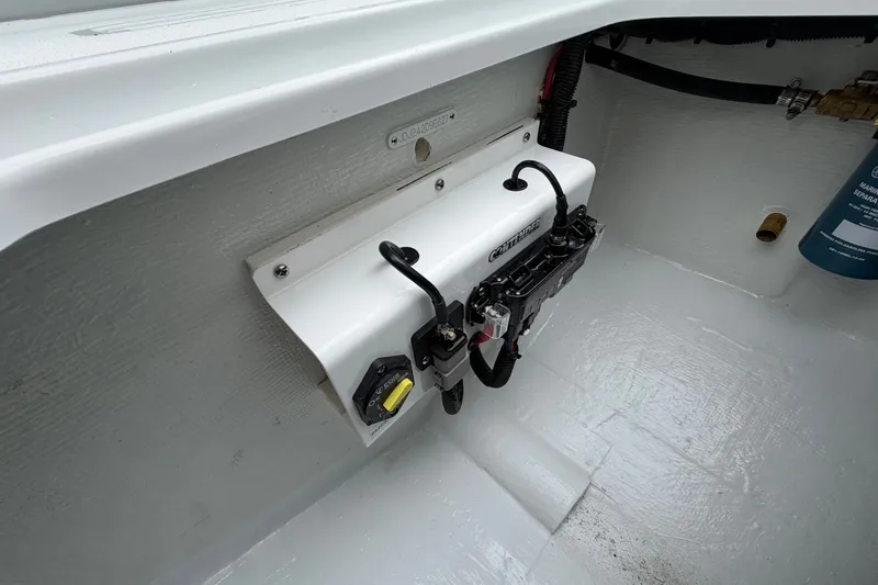Slide: The Image of Electrical panel in a 2027 Contender 24 Sport boat, featuring wiring and components. - 15