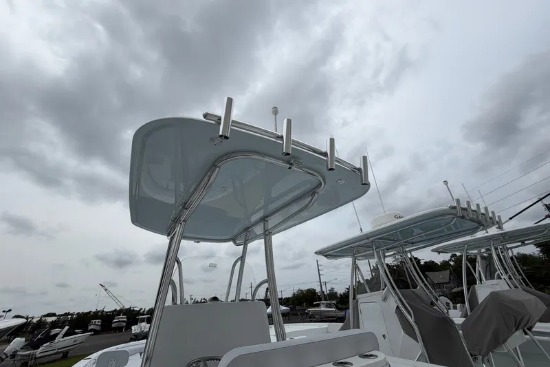 Slide: The Image of 2027 Contender 24 Sport boat with T-top under cloudy sky. - 13