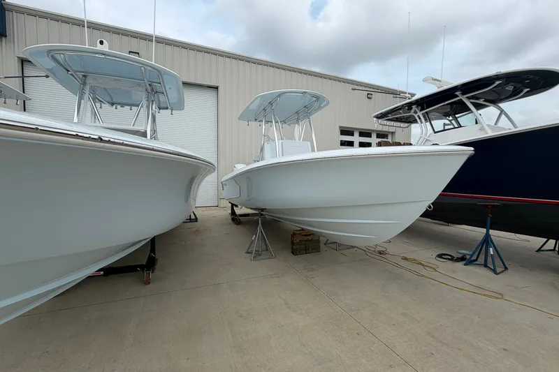 Slide: The Image of 2027 Contender 24 Sport boats displayed outside a warehouse on a cloudy day. - 1