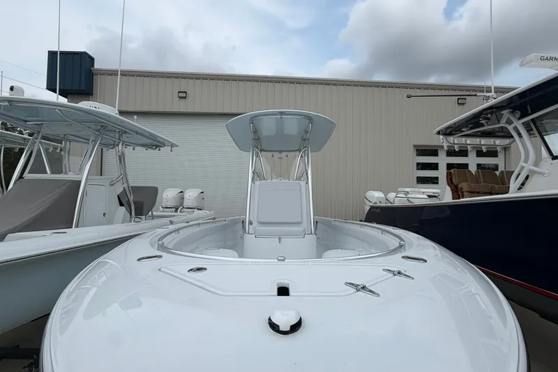 Slide: The Image of 2027 Contender 24 Sport boat docked, showcasing sleek design and modern features. - 2