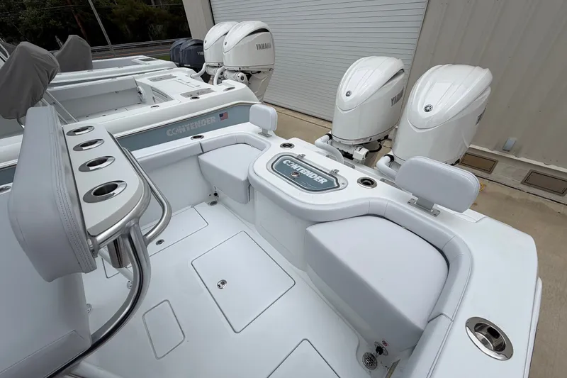 Slide: The Image of 2027 Contender 24 Sport boat with Yamaha engines, featuring sleek seating and rod holders. - 12
