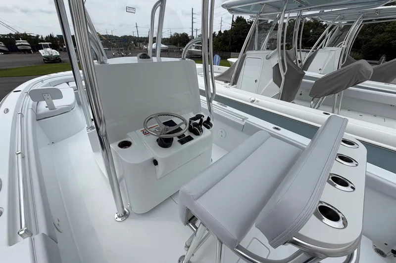 Slide: The Image of 2027 Contender 24 Sport boat interior with steering console and seating. - 9