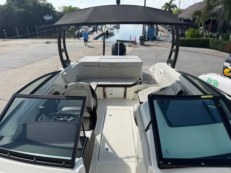 Slide: The Image of The image shows the cockpit of a 2022 Sea Ray SPX 230 Outboard boat with modern seating. - 13