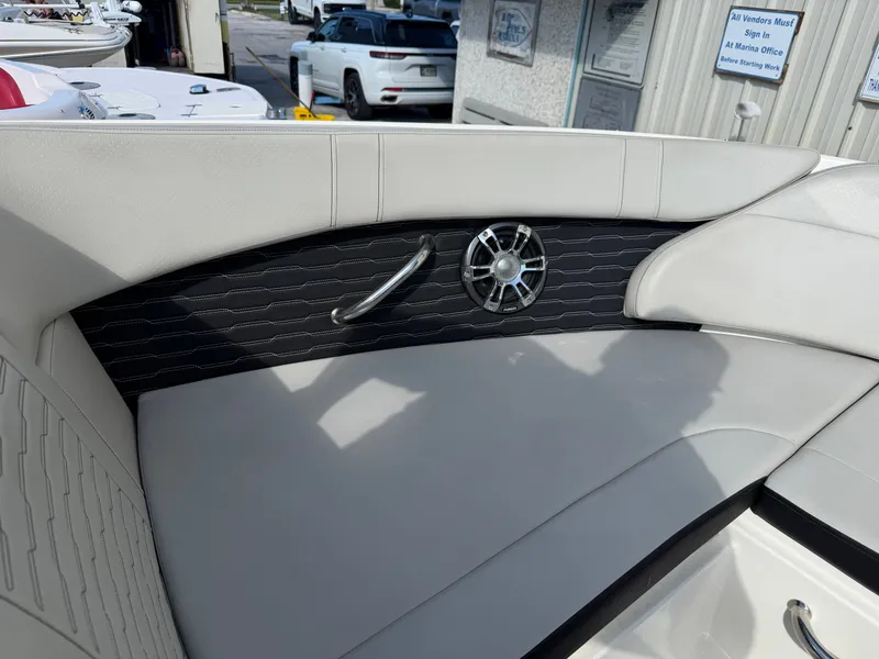 Slide: The Image of The image shows the interior of a 2022 Sea Ray SPX 230 Outboard with sleek seating and a speaker. - 11