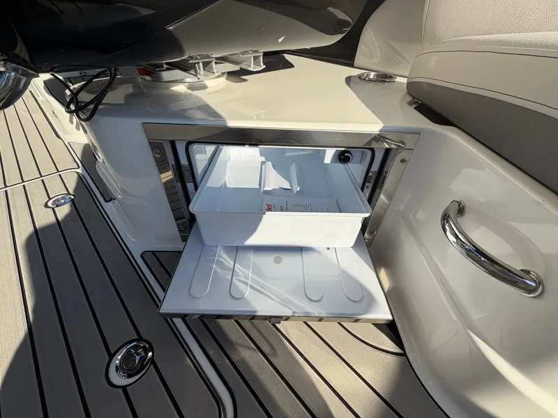 Slide: The Image of An open cooler compartment on a 2027 Sea Ray SLX 280 Outboard boat. - 19
