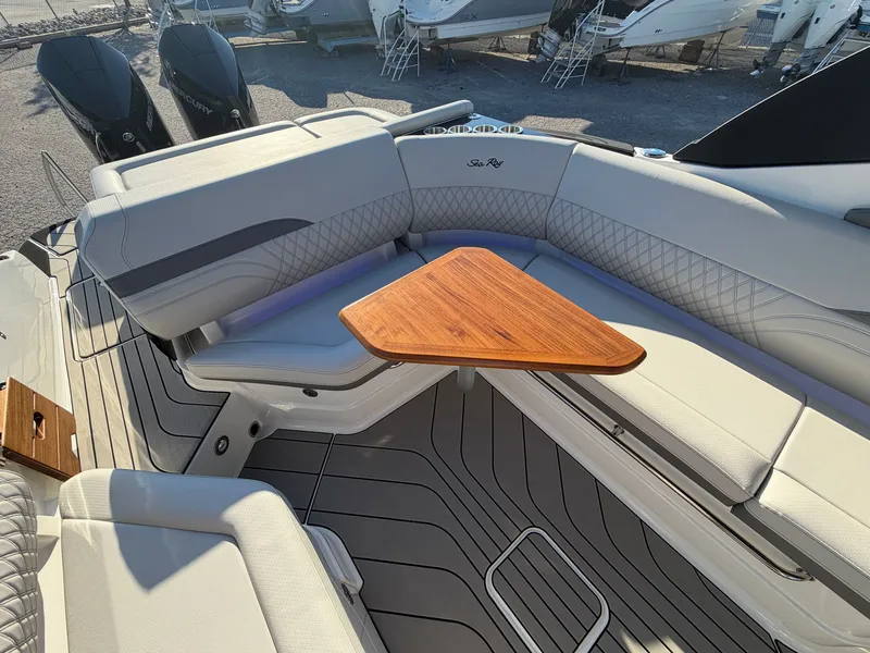 Slide: The Image of The 2027 Sea Ray SLX 280 Outboard features a luxurious seating area with a sleek wooden table. - 15