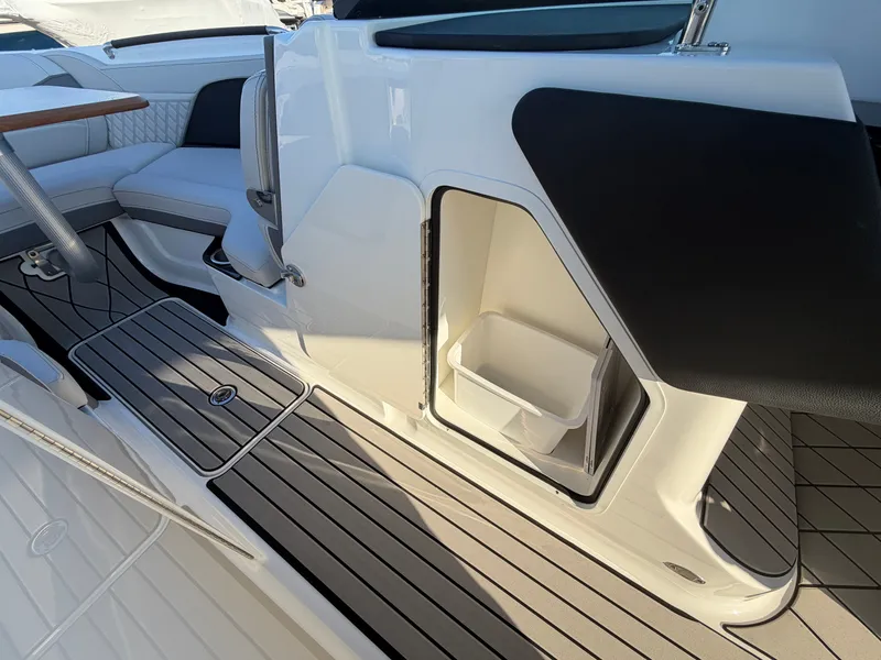 Slide: The Image of The image shows the cockpit of a 2027 Sea Ray SLX 280 Outboard with sleek seating and storage. - 36