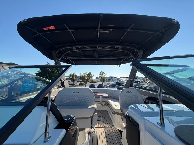 Slide: The Image of The image shows the cockpit of a Sea Ray SLX 280 Outboard with luxurious seating and a large sunshade. - 44