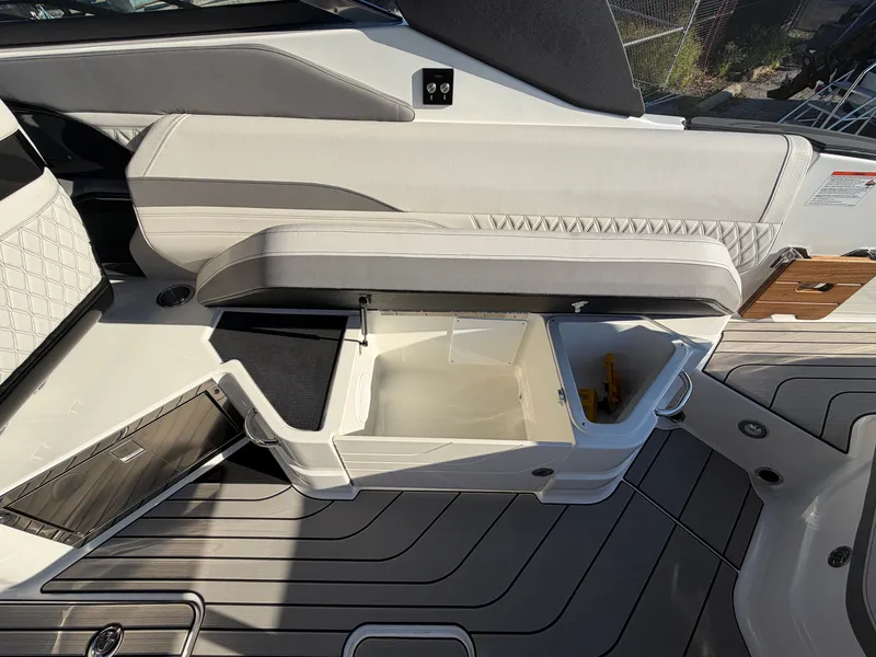 Slide: The Image of The image shows the interior of a Sea Ray SLX 280 Outboard with storage and sleek upholstery. - 17