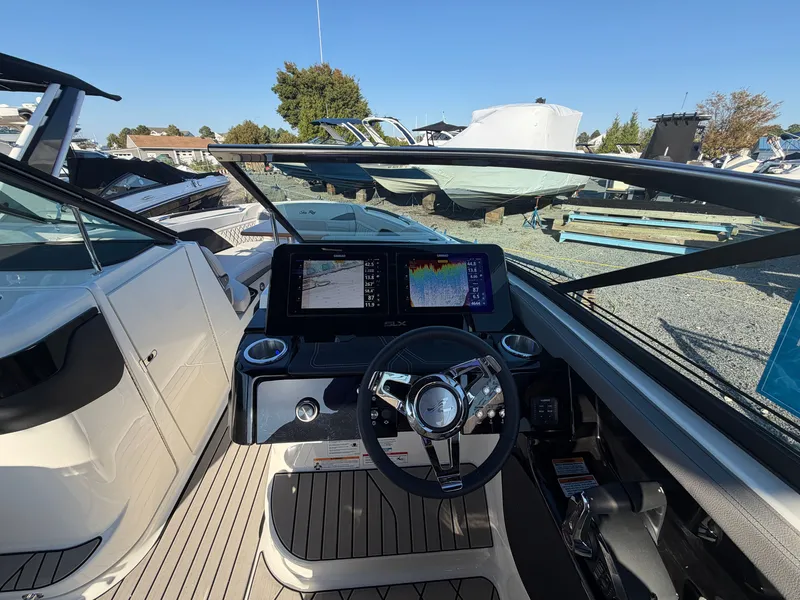 Slide: The Image of The image shows the cockpit of a Sea Ray SLX 280 Outboard with a modern helm and two screens. - 31