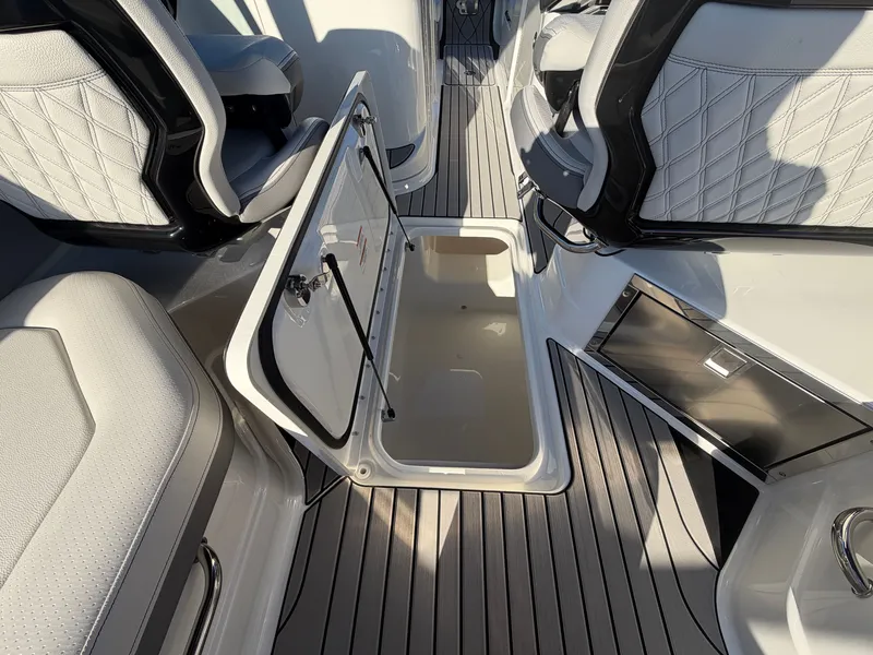 Slide: The Image of Interior of the 2027 Sea Ray SLX 280 Outboard with an open storage hatch and sleek seating. - 23