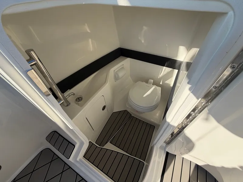 Slide: The Image of The 2027 Sea Ray SLX 280 Outboard cabin features a compact toilet with modern fixtures. - 43