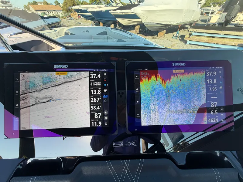 Slide: The Image of Two Simrad screens display navigation and sonar data on a Sea Ray SLX 280 Outboard. - 32