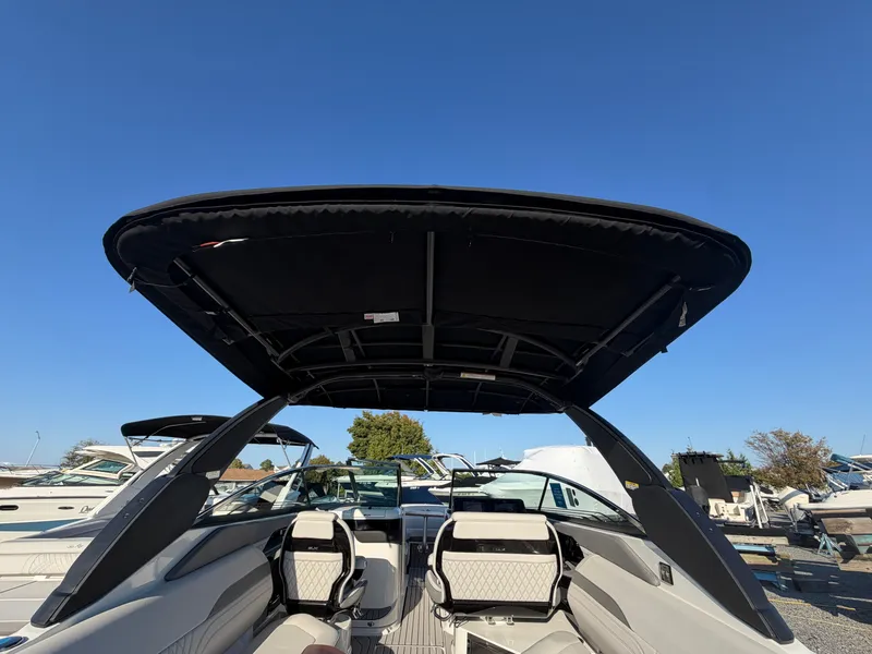 Slide: The Image of The image shows the cockpit of a Sea Ray SLX 280 Outboard with modern seating and a large sunshade. - 20
