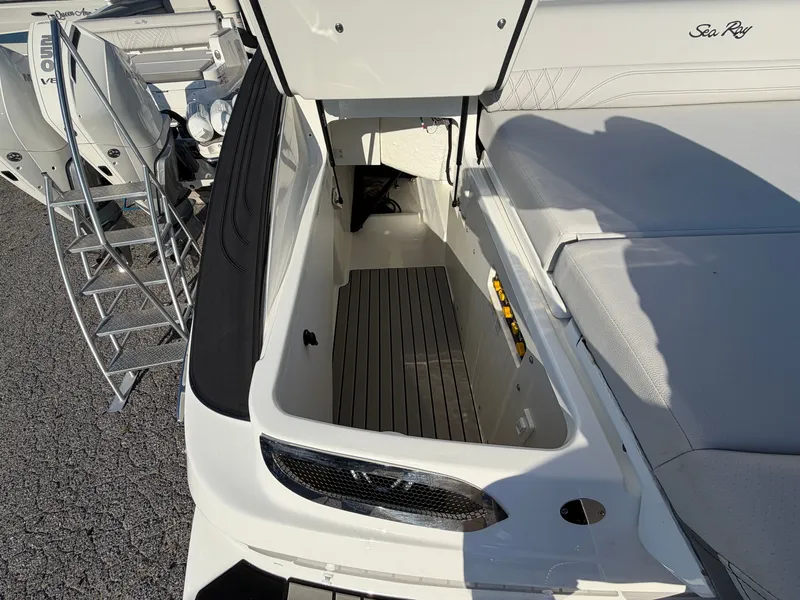 Slide: The Image of The image shows the storage area of a 2027 Sea Ray SLX 280 Outboard with a gray floor. - 10