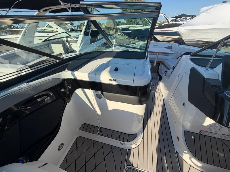 Slide: The Image of The image shows the cockpit of a 2027 Sea Ray SLX 280 Outboard with sleek seating and modern controls. - 42