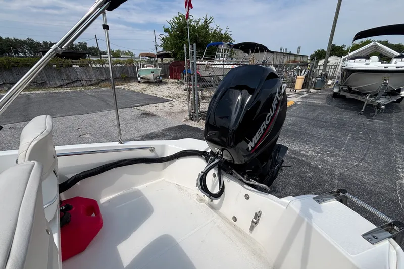 Slide: The Image of 2025 Boston Whaler 130 Super Sport with Mercury outboard motor in a boatyard. - 28