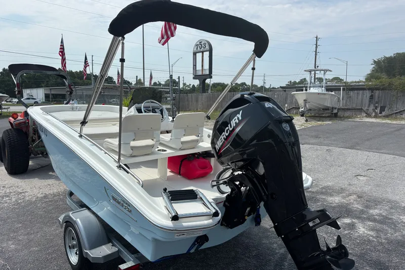 Slide: The Image of 2025 Boston Whaler 130 Super Sport boat with Mercury engine on trailer. - 10