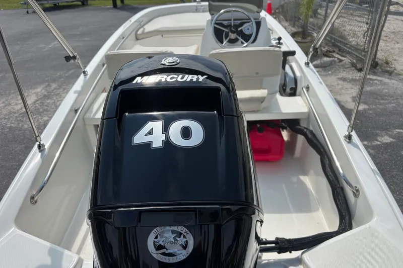 Slide: The Image of 2025 Boston Whaler 130 Super Sport boat with Mercury 40 engine, interior view. - 12
