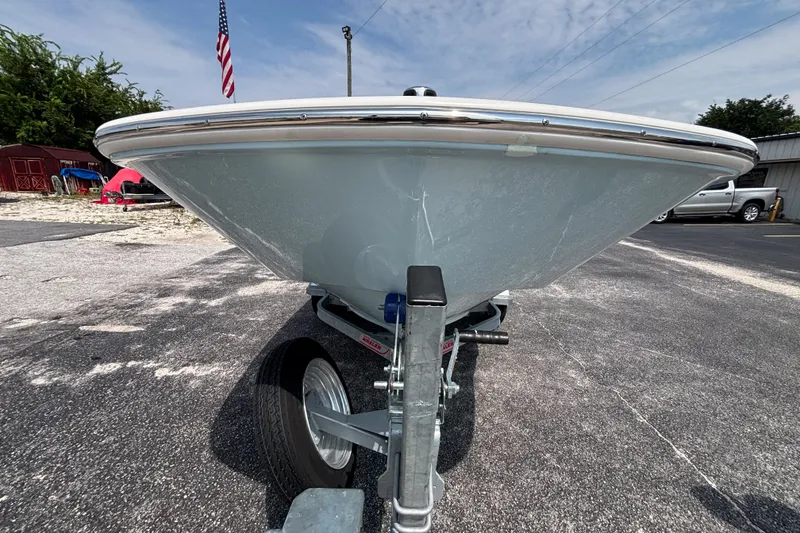 Slide: The Image of 2025 Boston Whaler 130 Super Sport boat on trailer, front view, outdoors. - 29