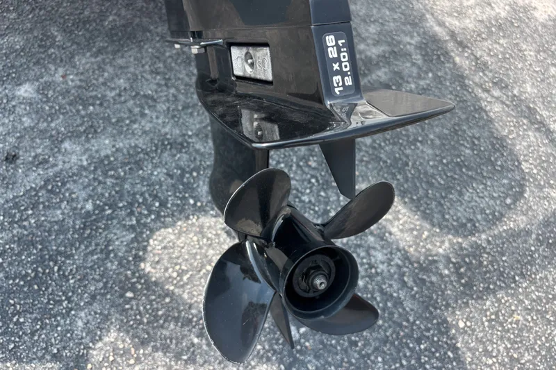 Slide: The Image of Propeller of 2025 Boston Whaler 130 Super Sport on asphalt surface. - 14