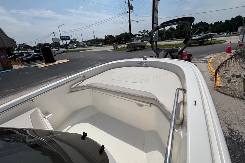 Slide: The Image of 2025 Boston Whaler 130 Super Sport boat interior at a dealership parking lot. - 20