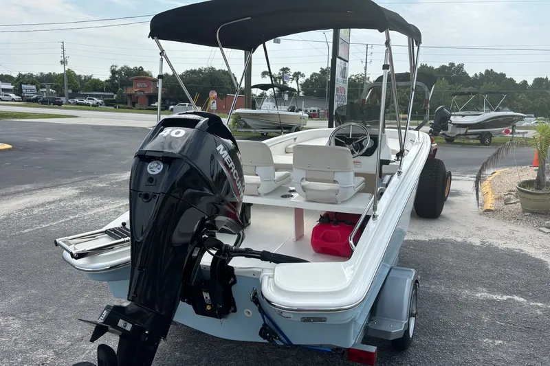 Slide: The Image of 2025 Boston Whaler 130 Super Sport boat with Mercury engine on trailer. - 7