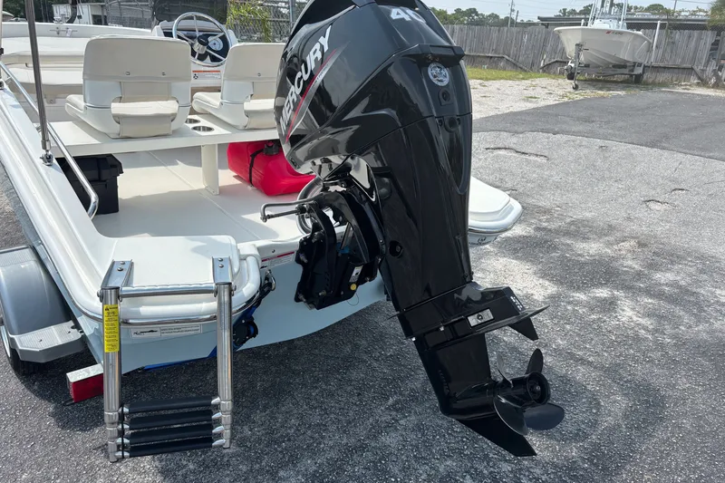 Slide: The Image of 2025 Boston Whaler 130 Super Sport with Mercury outboard motor and ladder. - 11