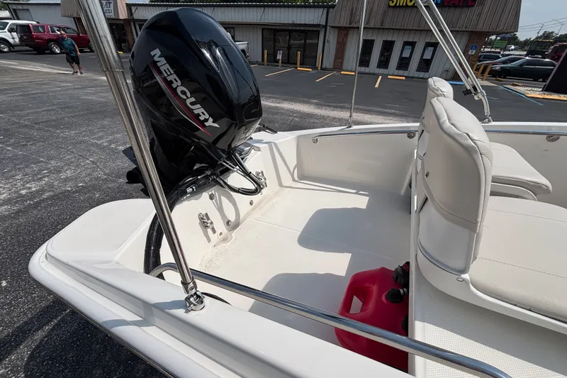 Slide: The Image of 2025 Boston Whaler 130 Super Sport boat with Mercury engine, parked in a lot. - 19