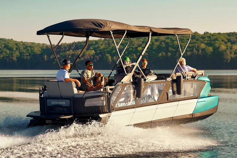 Slide: The Image of Manufacturer Provided Image: 2022 Sea-Doo Switch Cruise 21 pontoon boat cruising on a lake with passengers. - 13